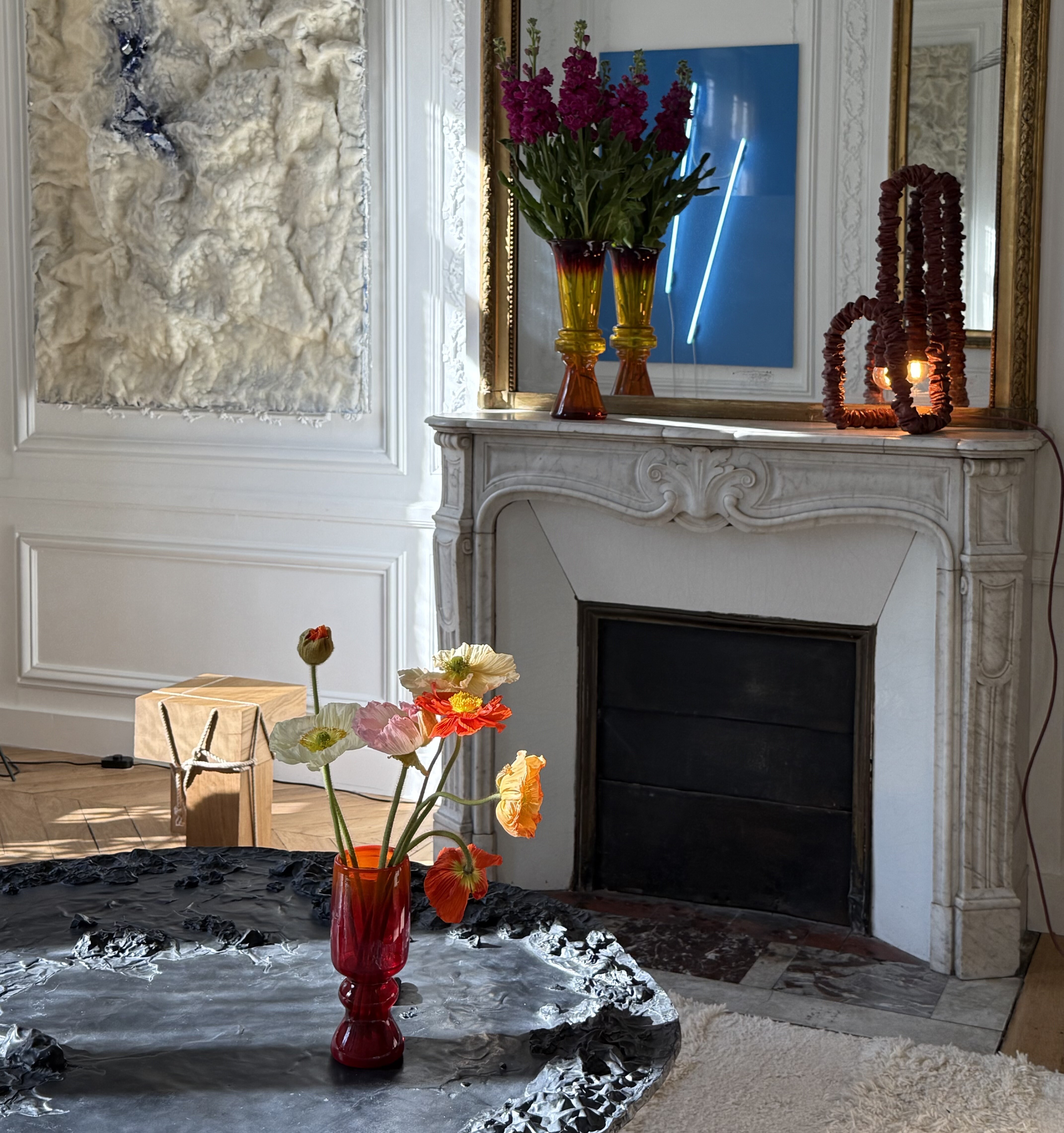The grand salon of Maison Markul, the fireplace and the blue neon